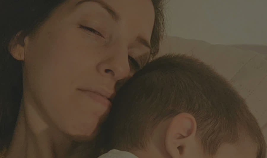 Hila with her youngest child asleep on her